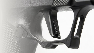 Close-up of a handgun trigger and grip texture detail